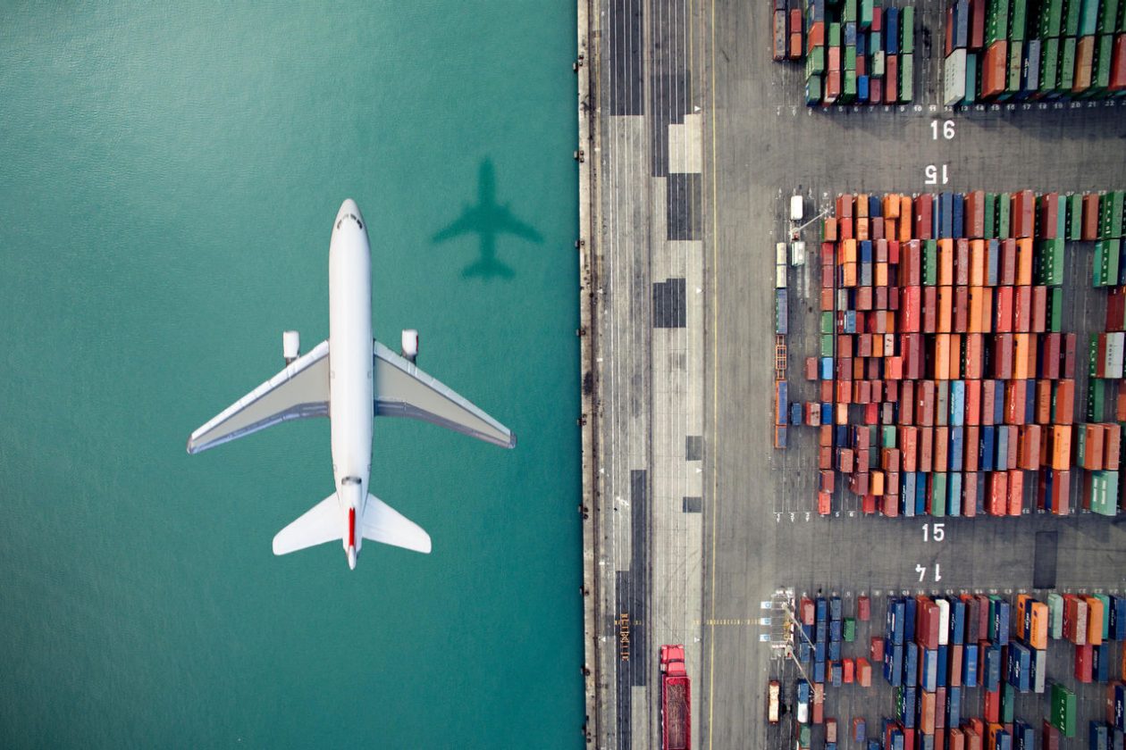 Airplane over Container Port